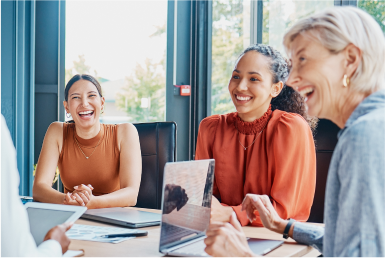 Become an Agile Coach Businesspeople laugh joyfully in a meeting room