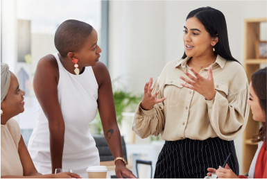 How it works Colleagues in conversation in an office