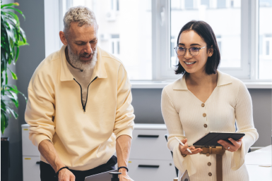 Scrum benefits Two coworkers in discussion with a tablet