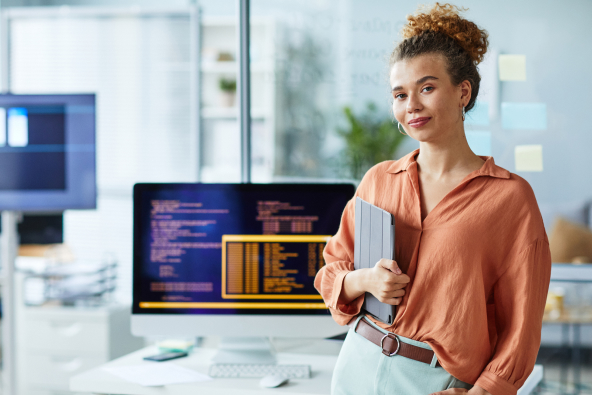 Smiling professional holding an ipad