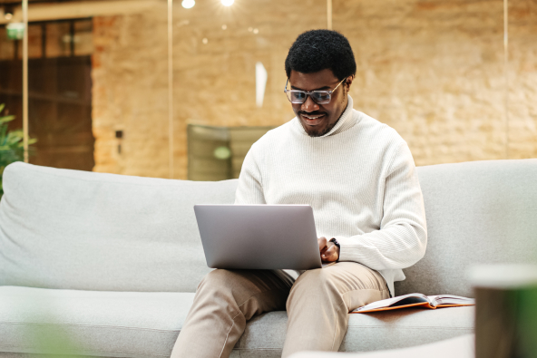 Professional male on a laptop sitting on a couch