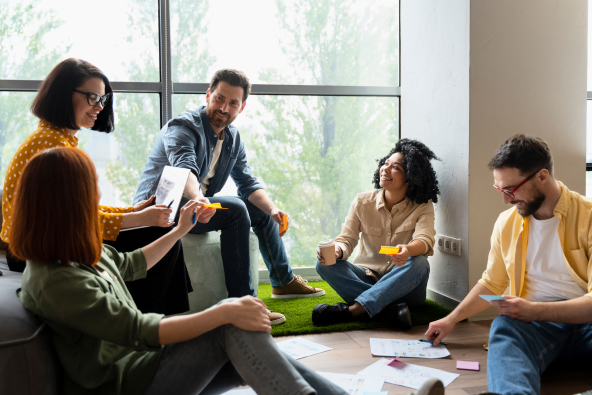 A group of co-workers in an office in conversation 