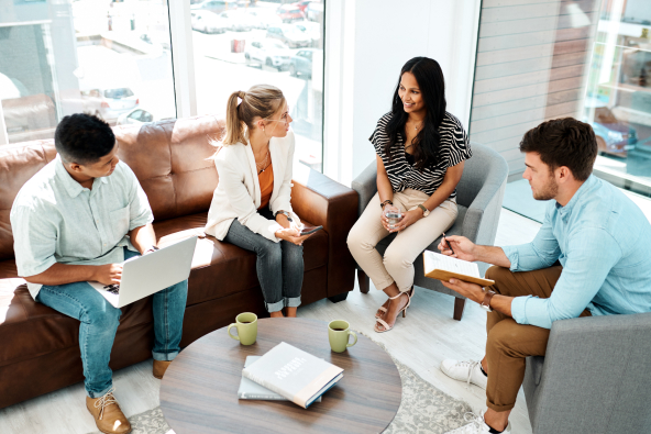 A group of colleagues meets in a modern room