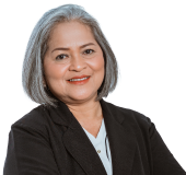 A professional businessperson poses for a portrait in a black blazer
