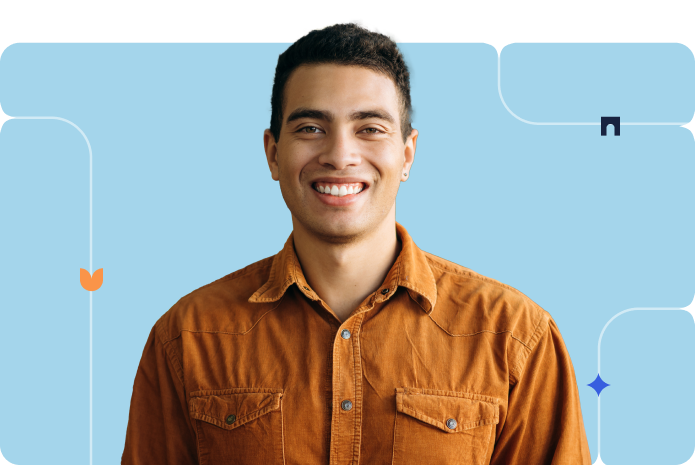 A person poses in an orange button-up in front of a blue background