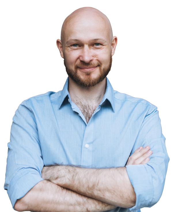 A businessperson poses with his arms crossed and smiling