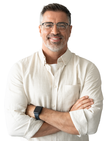 A man wearing glasses and a white button up crosses his arms and smiles against a white background