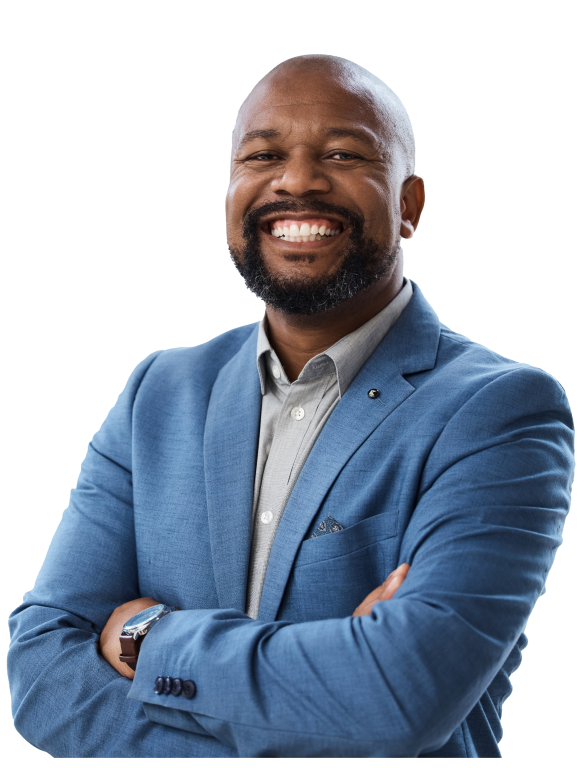 A businessman in a blue blazer smiles and poses with arms crossed across his chest