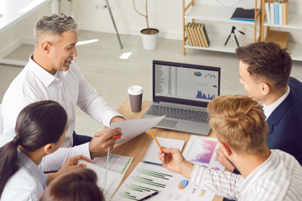 Co-workers discussing graphs