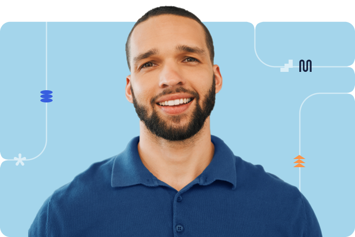 Smiling male professional wearing a blue collared shirt in a light blue background